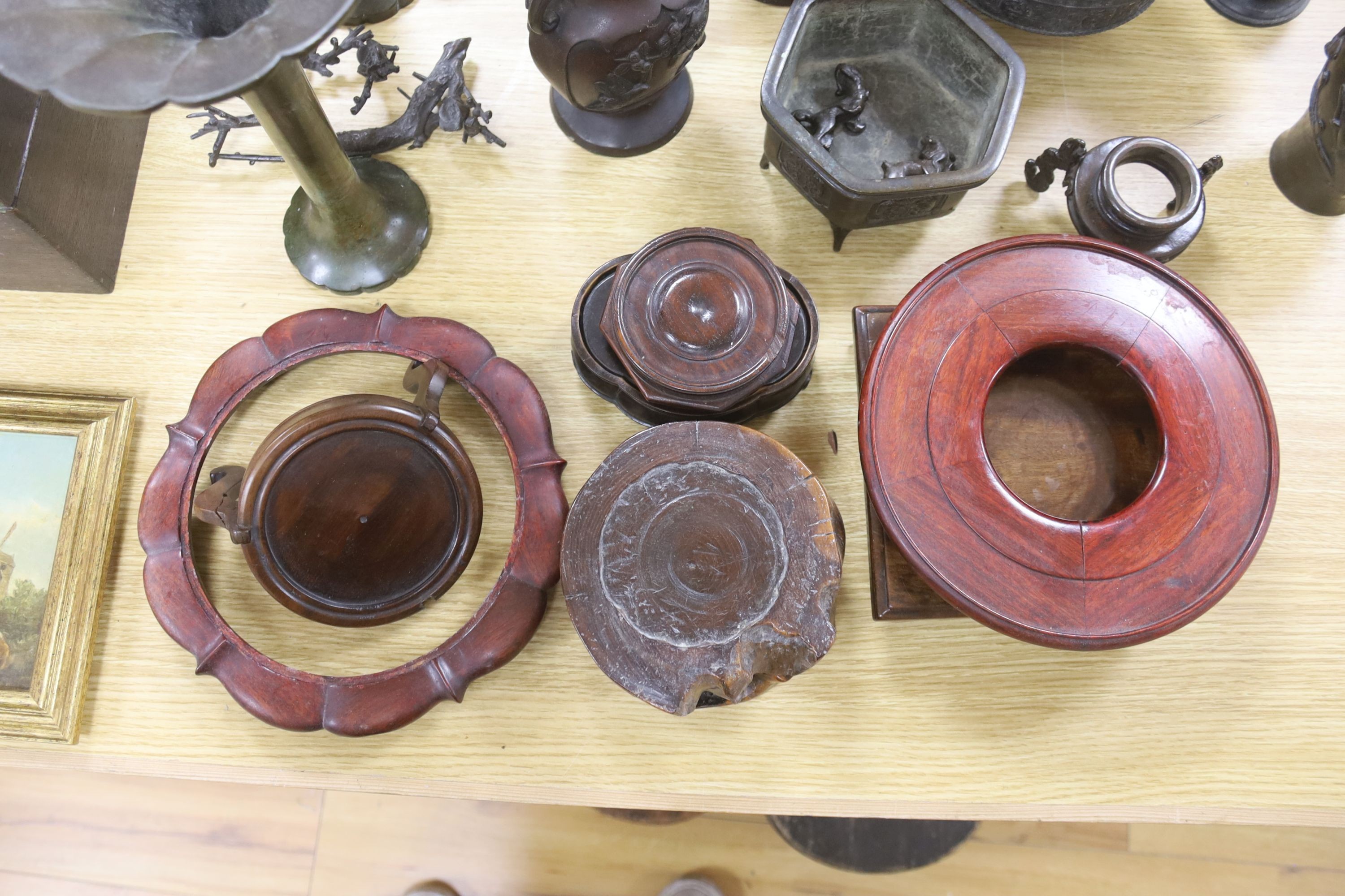 A group of Japanese bronze vases and sundry hardwood stands